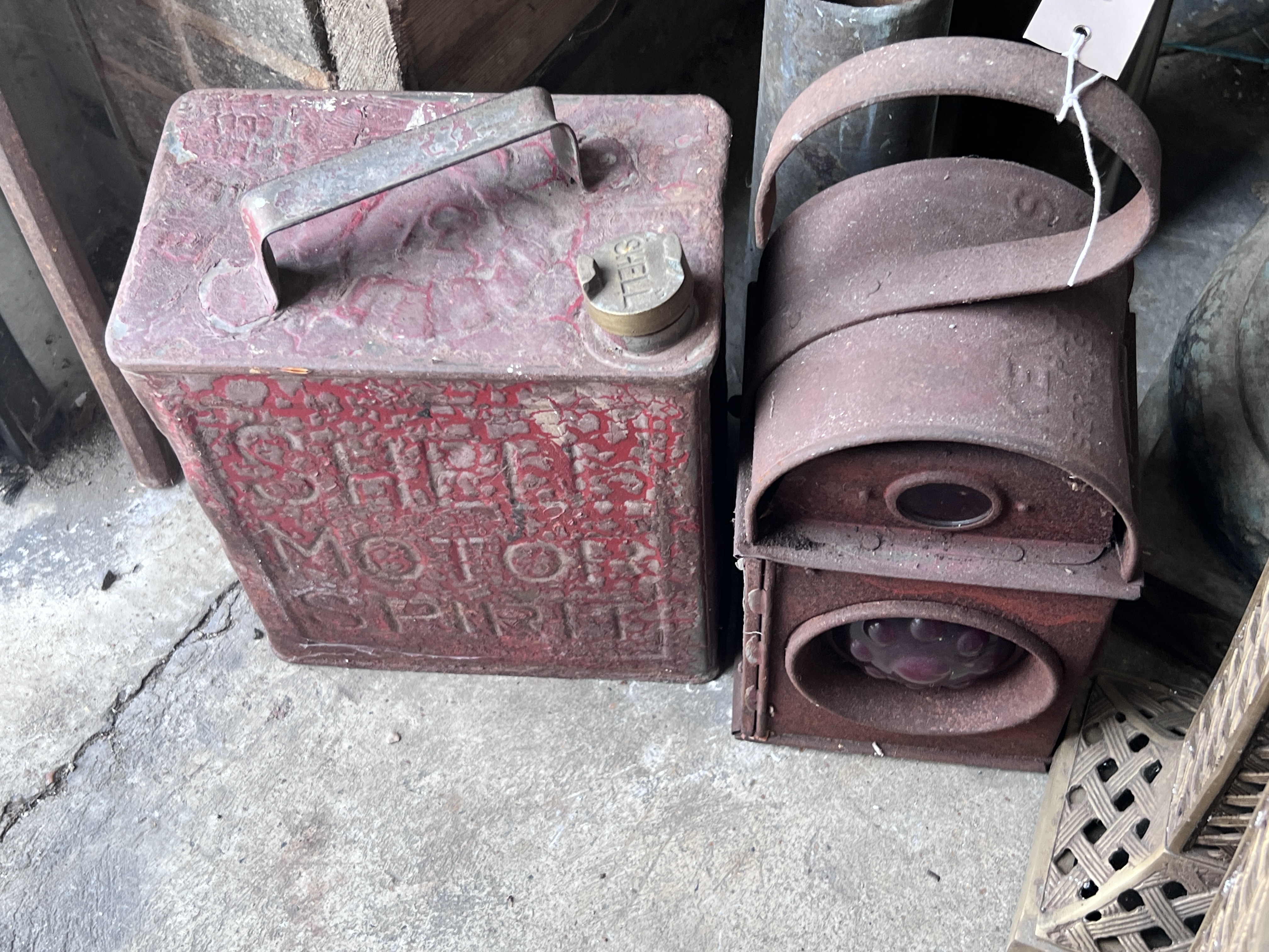 A vintage Shell petrol can, a road lamp, two shell cases and two brass lidded holders